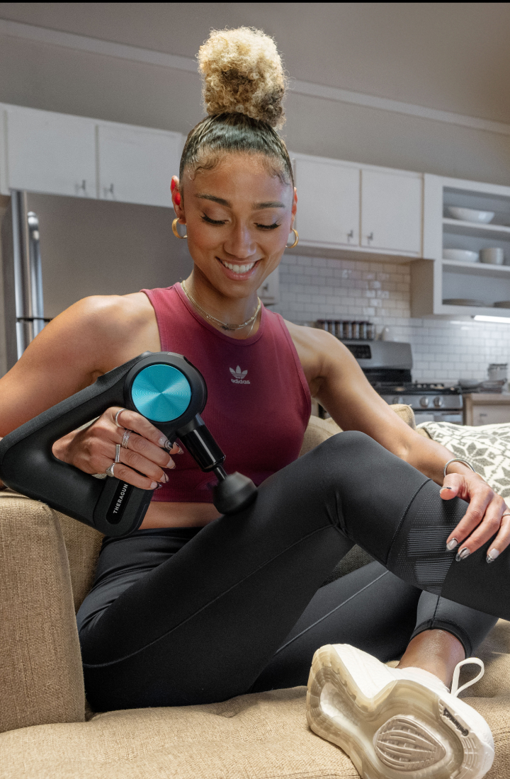 Ally Love posing with Theragun PRO Device